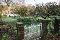Gate from the wild garden looking towards the orchard and house