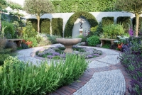 Circular water bowl surrounded by a carpet of Thyme in a modern herb garden