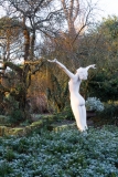 Winter in the formal Italianate garden at Borde Hill with a nude statue of a woman with outstretched arms in foreground