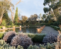 Winter in the formal Italianate garden at Borde Hill with a nude statue of a woman with outstretched arms in background