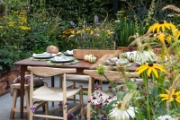Contemporary edible garden with raised beds containing vegetables, herbs and perennials
