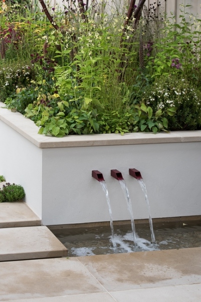 Water shoots in a low wall with raised bed behind