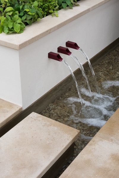 Water shoots in a low wall with raised bed behind