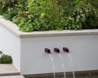 Water shoots in a low wall with raised bed behind