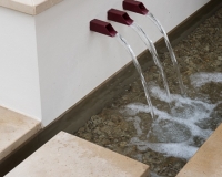 Water shoots in a low wall with raised bed behind