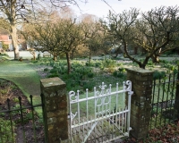 Gate from the wild garden looking towards the orchard and house