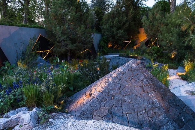 Lighting geometric shapes and basalt mounds in a contemporary mediterranean garden
