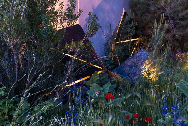 Lighting geometric shapes and basalt mounds in a contemporary mediterranean garden