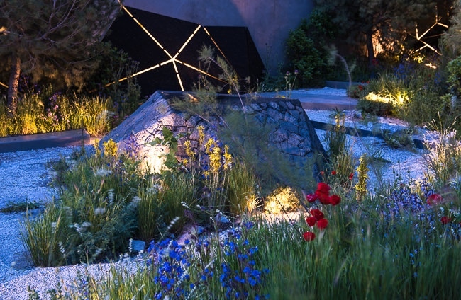 Lighting geometric shapes and basalt mounds in a contemporary mediterranean garden