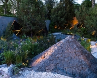 Lighting geometric shapes and basalt mounds in a contemporary mediterranean garden