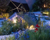 Lighting geometric shapes and basalt mounds in a contemporary mediterranean garden
