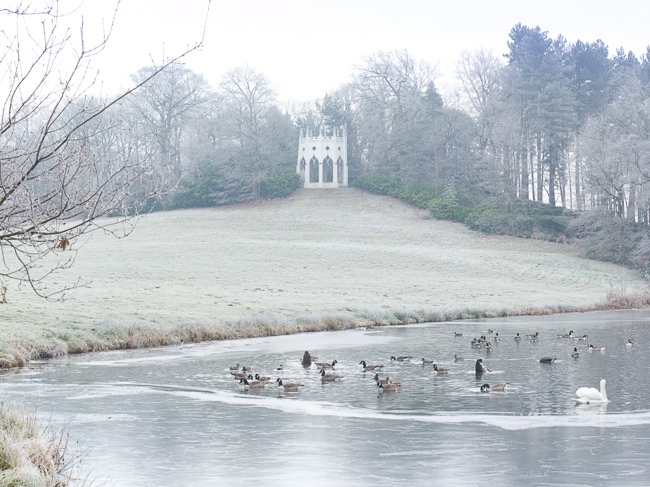 Painshill Park landscape garden overlooking the frozen lake with the Gothic Temple in the background