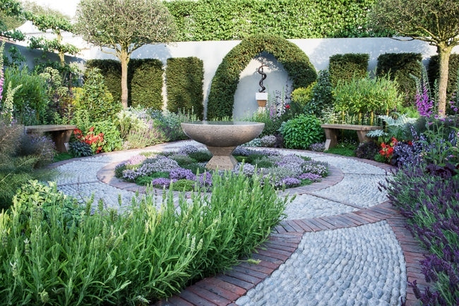 Circular water bowl surrounded by a carpet of Thyme in a modern herb garden