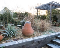 Steps made out of oak sleepers lead up to a different level in a gravel garden
